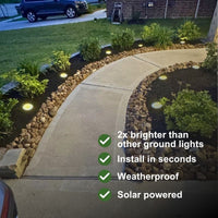 Solar-powered ground lights illuminated along a curved concrete walkway in a landscaped garden bed with rocks and greenery at night. White text overlays on the right list product benefits: 2x brighter than other ground lights, install in seconds, weatherproof, and solar powered.